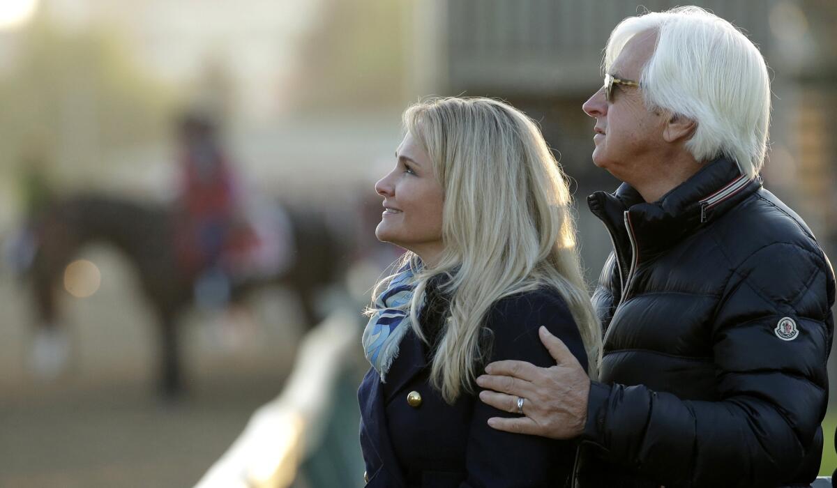 Trainer Bob Baffert and wife Jill watch horses train on the Churchill Downs track on Wednesday before the draw for post position.