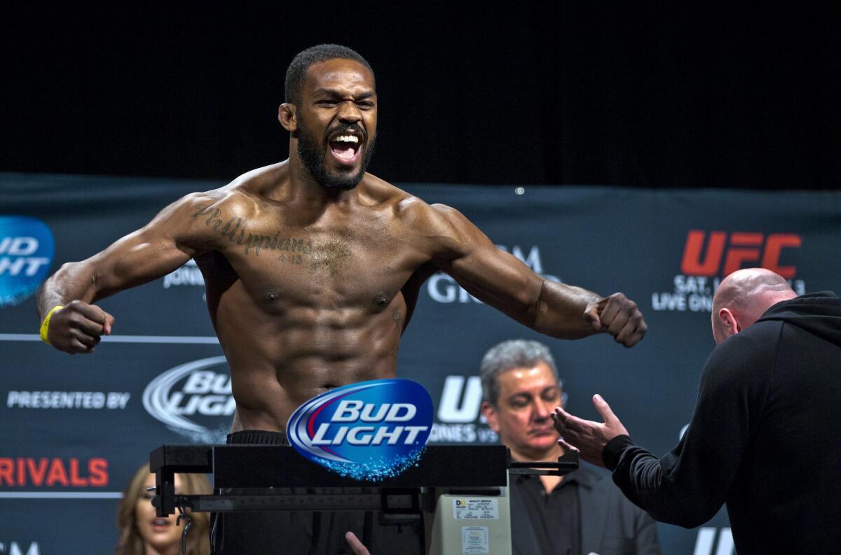 Jon Jones flexes for the fans during the weigh-in for UFC 182 on Jan. 2, 2015, in Las Vegas.