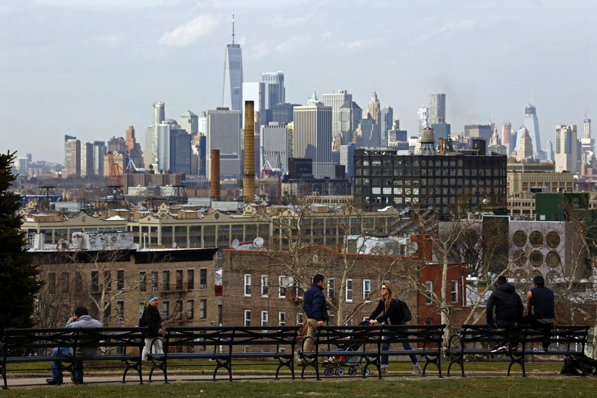 People young and old gather in Sunset Park, which has views of Industry City and of Manhattan.