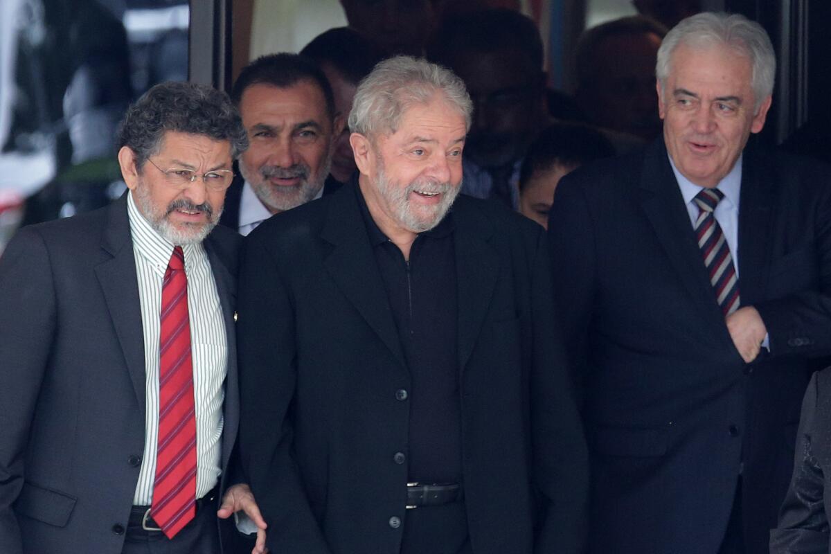 Brazil’s former President Luiz Inacio Lula da Silva, center, leaves a breakfast with senators in Brasilia.