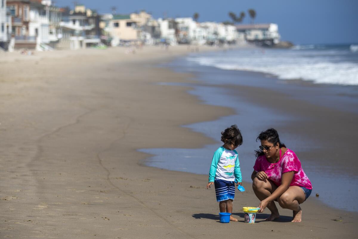 A woman and child on the beach