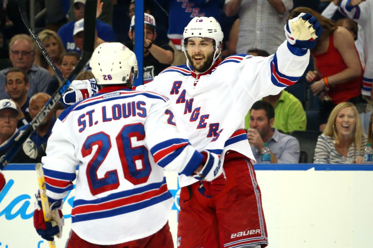 New York Rangers forwards Martin St. Louis (26) and Derick Brassard celebrate after a goal against the Tampa Bay Lightning in Game 4 of the Eastern Conference finals.
