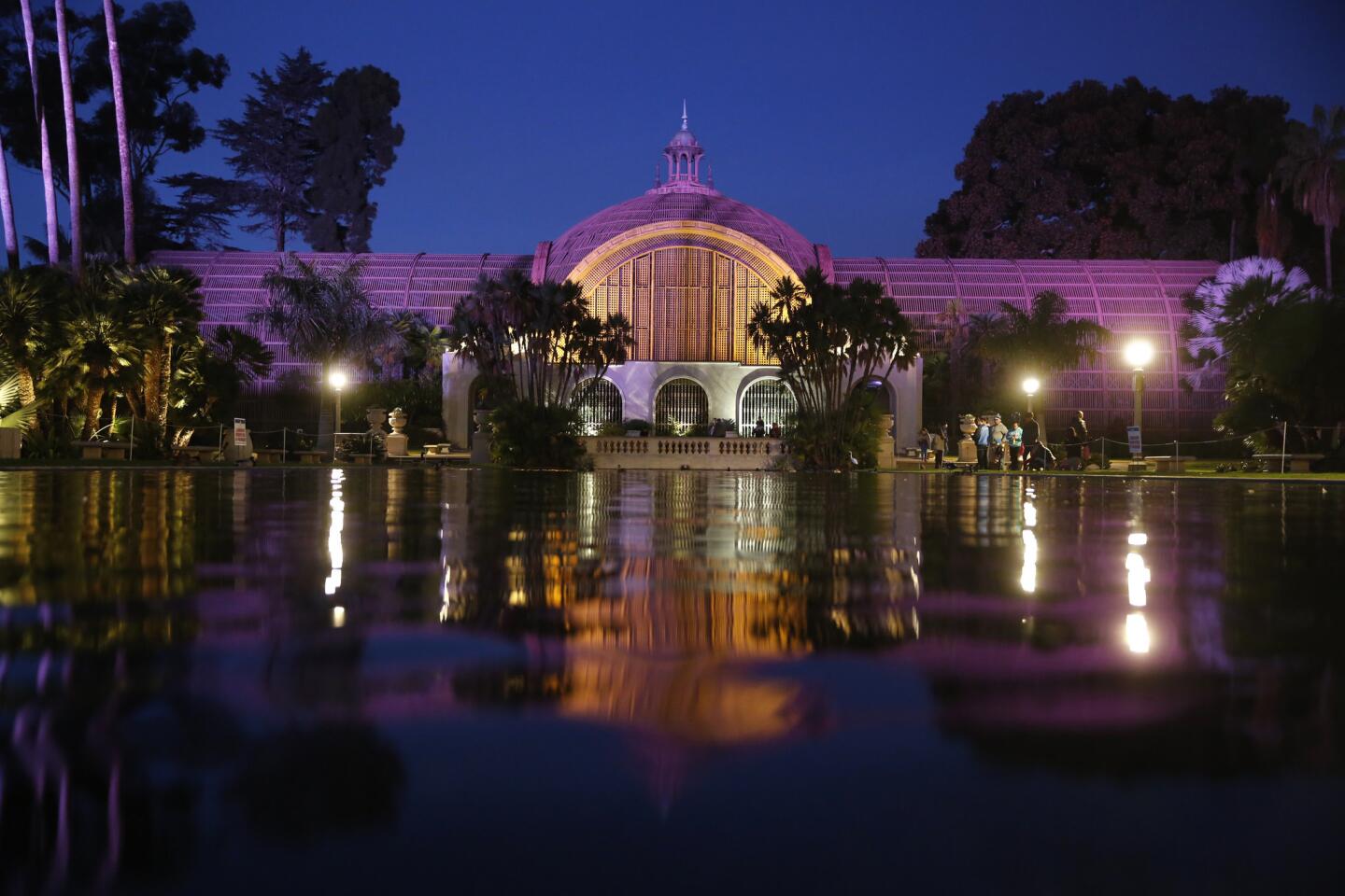 Variable color floodlights illuminate the Botanical Building, built for the 1915 Panama-California Exposition, at the end of the reflecting pond in San Diego's Balboa Park.