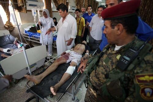 Wounded arrive at a Baghdad hospital after a roadside bomb attack in the Iraqi capital's Sadr City district.