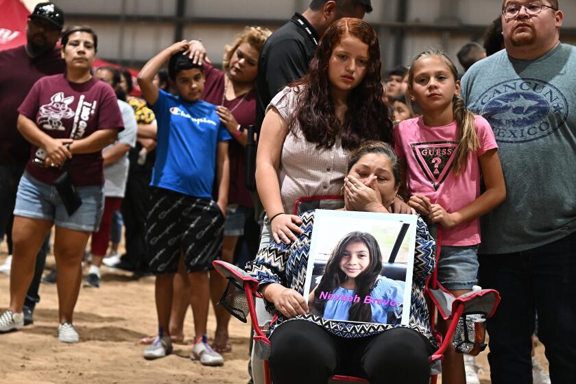 Uvalde, Texas May 25, 2022- Esmerralda Bravo holds a picture of her grandaughter Naveah, a shooting victim, Wednesday at the Uvalde County Fairplex to honor the fallen victims of a mass shooting during a vigil in Texas. Nineteen students and two teachers died when a gunman opened fire in a classroom yesterday. (Wally Skalij/Los Angeles Times)