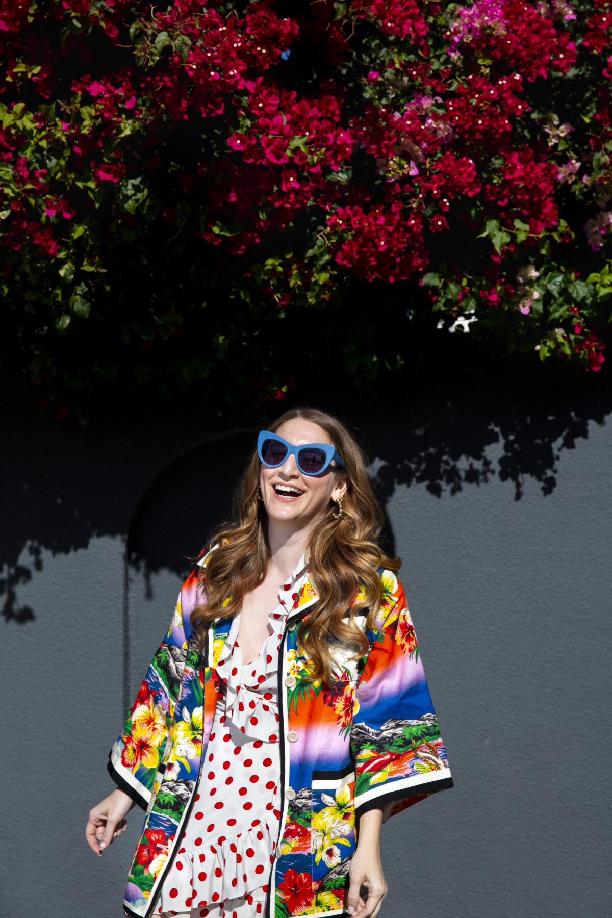 A colorfully dressed Denise Love Hewett in the courtyard of her Hollywood apartment.