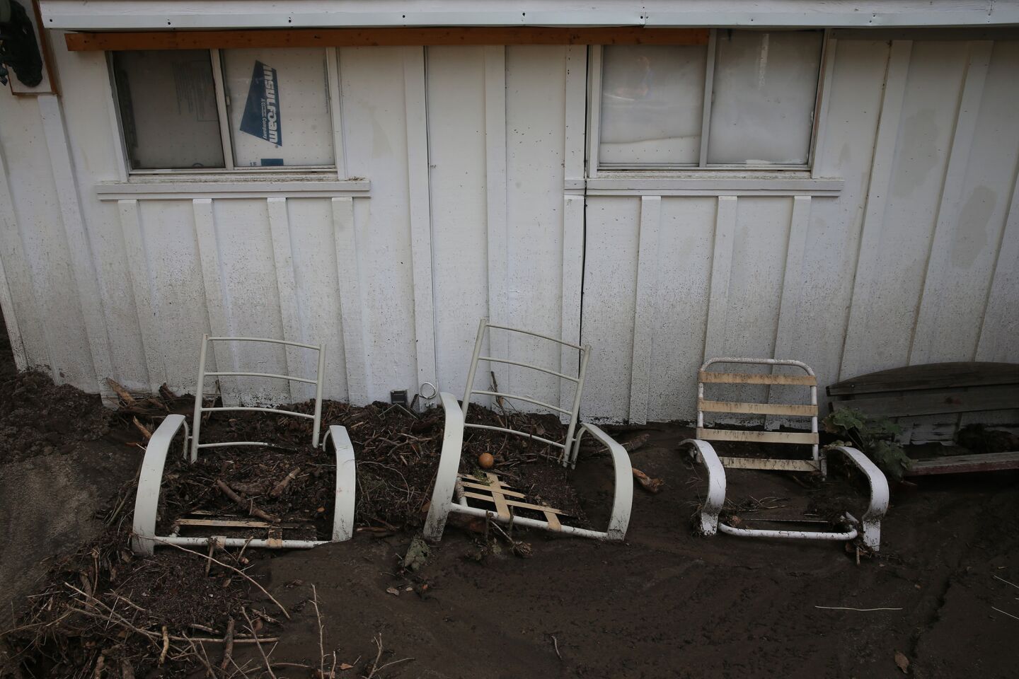 Patio furniture is stuck in several inches of mud outside the home of Jason DeBerge.