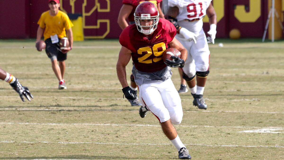 USC wide receiver Christian Tober runs with the ball after making a catch over the middle during a fall camp practice at Howard Jones Field.