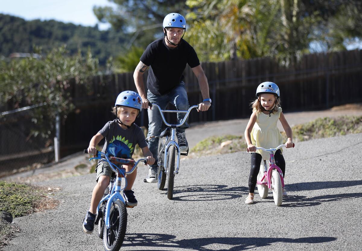 BMX World Champion Simon Tabron rides bikes at his Bonsall home Jan. 13 with his 6-year-old twins Dylan and Scarlett.  
