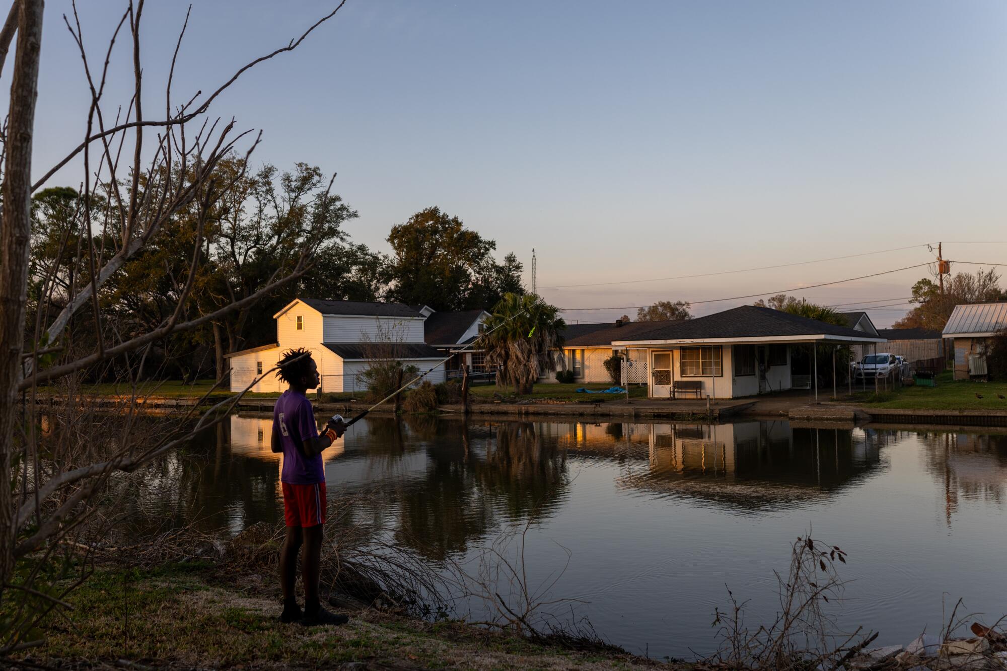 Latrevien Moultrie, 14, fishes in Houma, La.