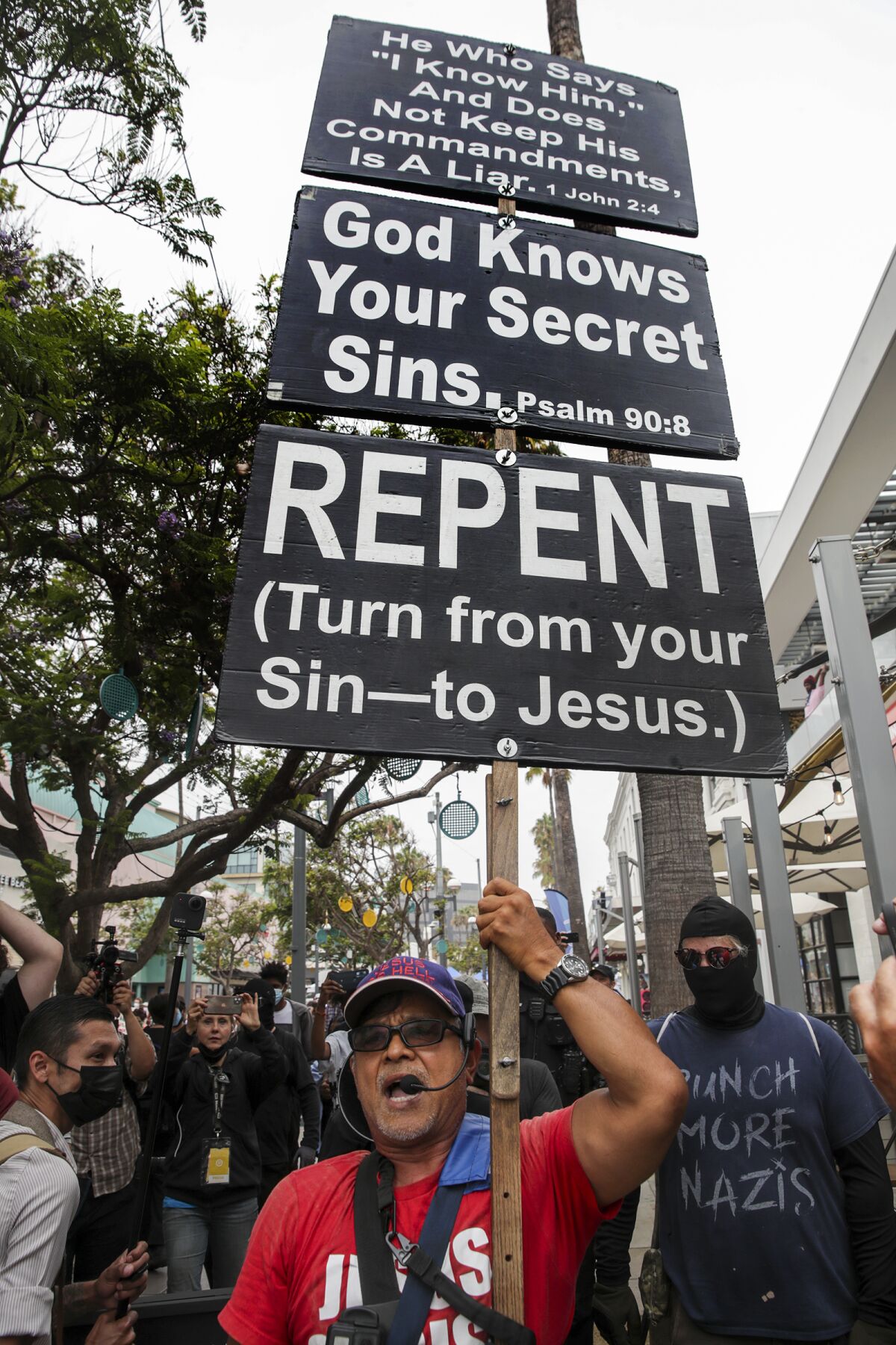 A man holds a sign with Bible verses amid an abortion-rights rally 