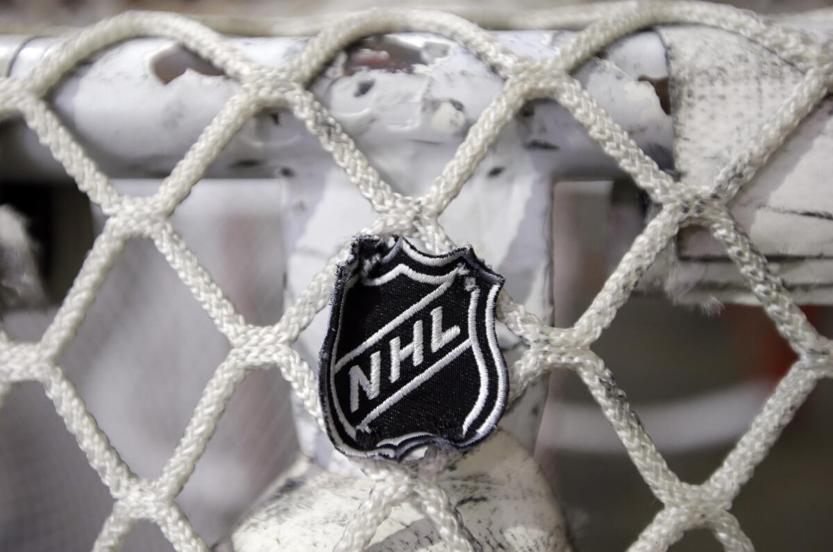 The NHL logo is seen on a goal at a Predators practice rink in Nashville, Tenn.