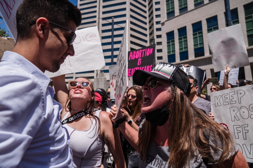 Abortion rights protesters and counter-protesters argue at a rally in downtown San Diego. 
