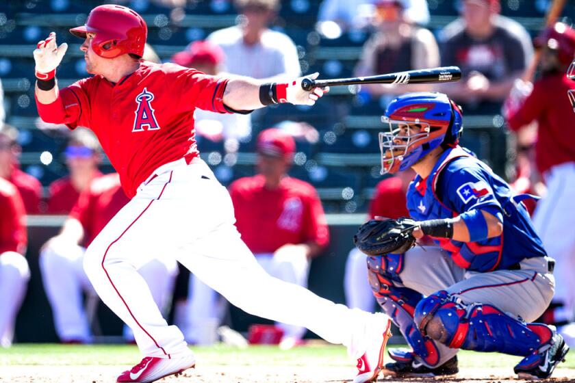 Angels outfielder Daniel Robertson bats during a 7-3 spring training game lost to the Texas Rangers on Friday.