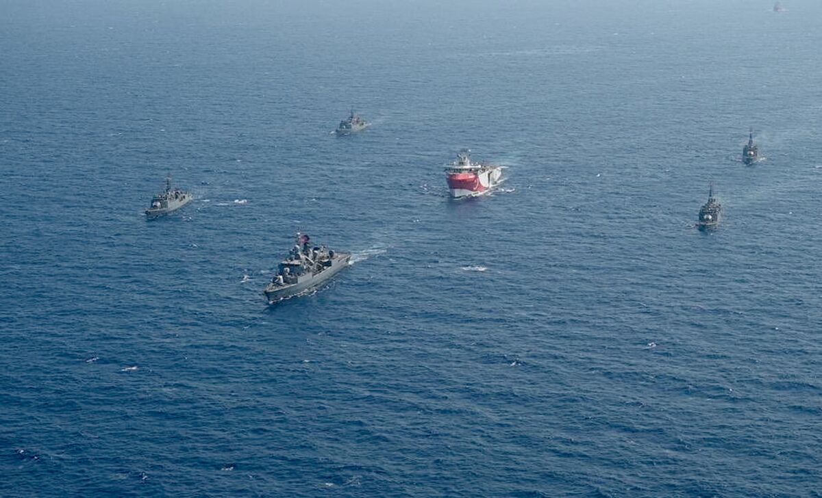 FILE - In this photo taken Monday, Aug. 10, 2020, Turkey's research vessel, Oruc Reis, center, is surrounded by Turkish navy vessels as it was heading in the west of Antalya on the Mediterranean, Turkey. Greece says it will conduct a navy and air force exercise in an area of the eastern Mediterranean where Turkey is prospecting for oil and gas in an area as the neighboring countries remain locked in a dispute over offshore energy rights. (IHA via AP)
