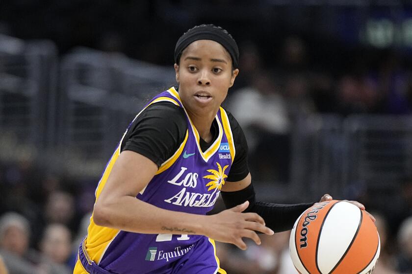 Sparks guard Jordin Canada dribbles looks up the court 