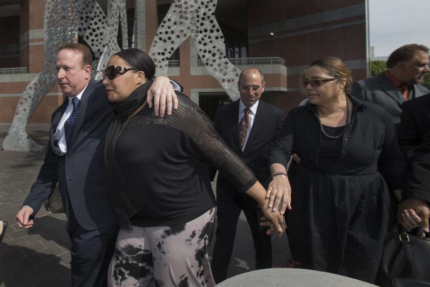 Nona Gaye, middle, daughter of the late Marvin Gaye, leaves the Roybal Federal Courthouse with attorney Richard Busch, left, and her dad's ex-wife Janice Gaye, right, after a federal jury found Pharrell Williams and Robin Thicke guilty of copyright infringement.