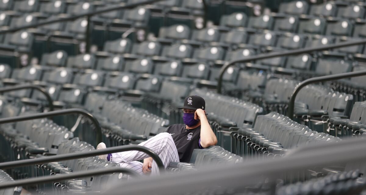Colorado Rockies relief pitcher Scott Oberg looks on from the right-field stands in the first inning of a baseball game against the San Diego Padres Friday, July 31, 2020, in Denver. (AP Photo/David Zalubowski)