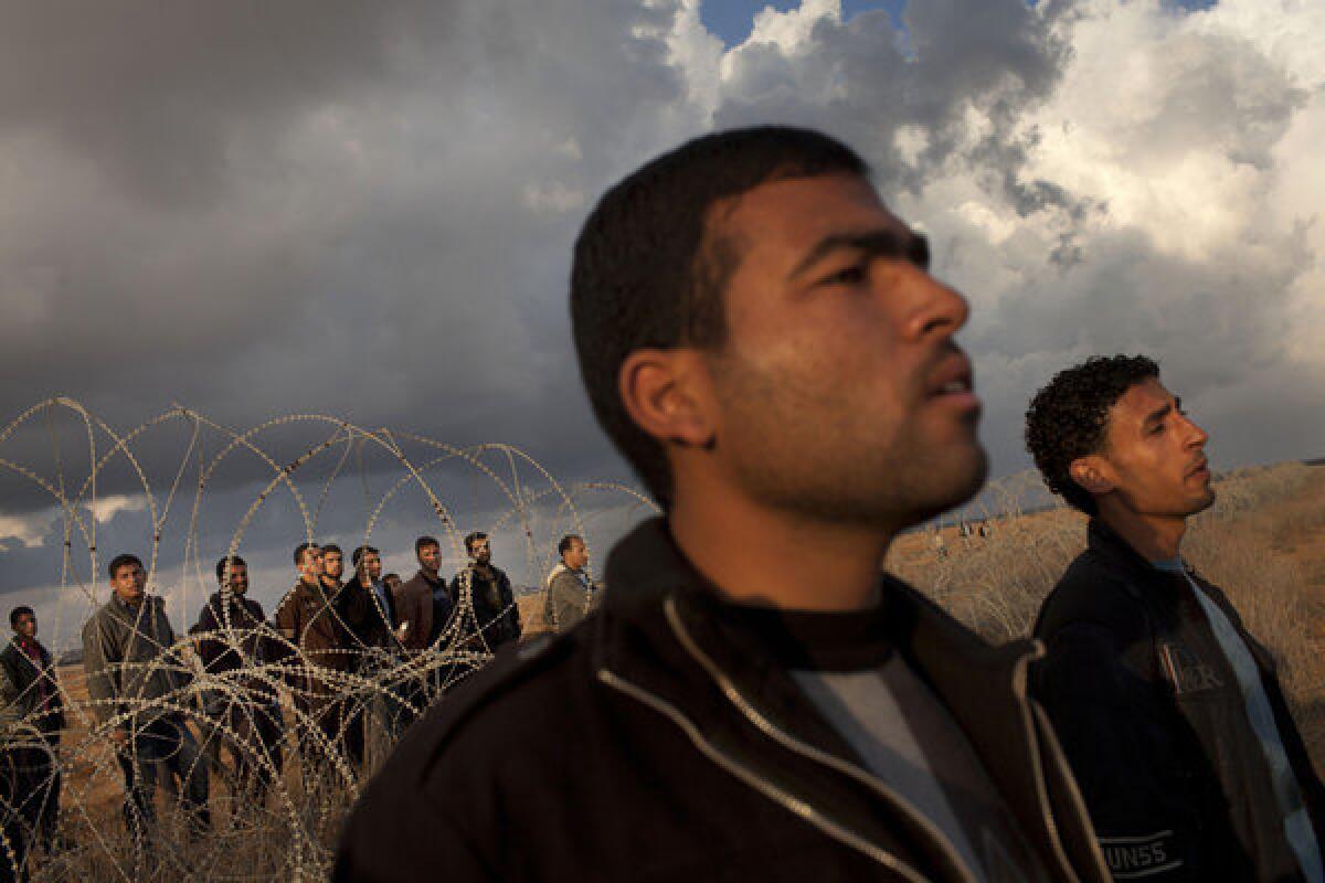 Palestinians gather Friday along the Israel-Gaza border fence east of Khan Younis in the southern Gaza Strip.