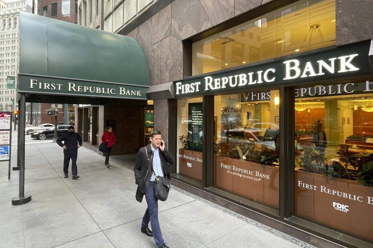 People walk past the headquarters of First Republic Bank in San Francisco.