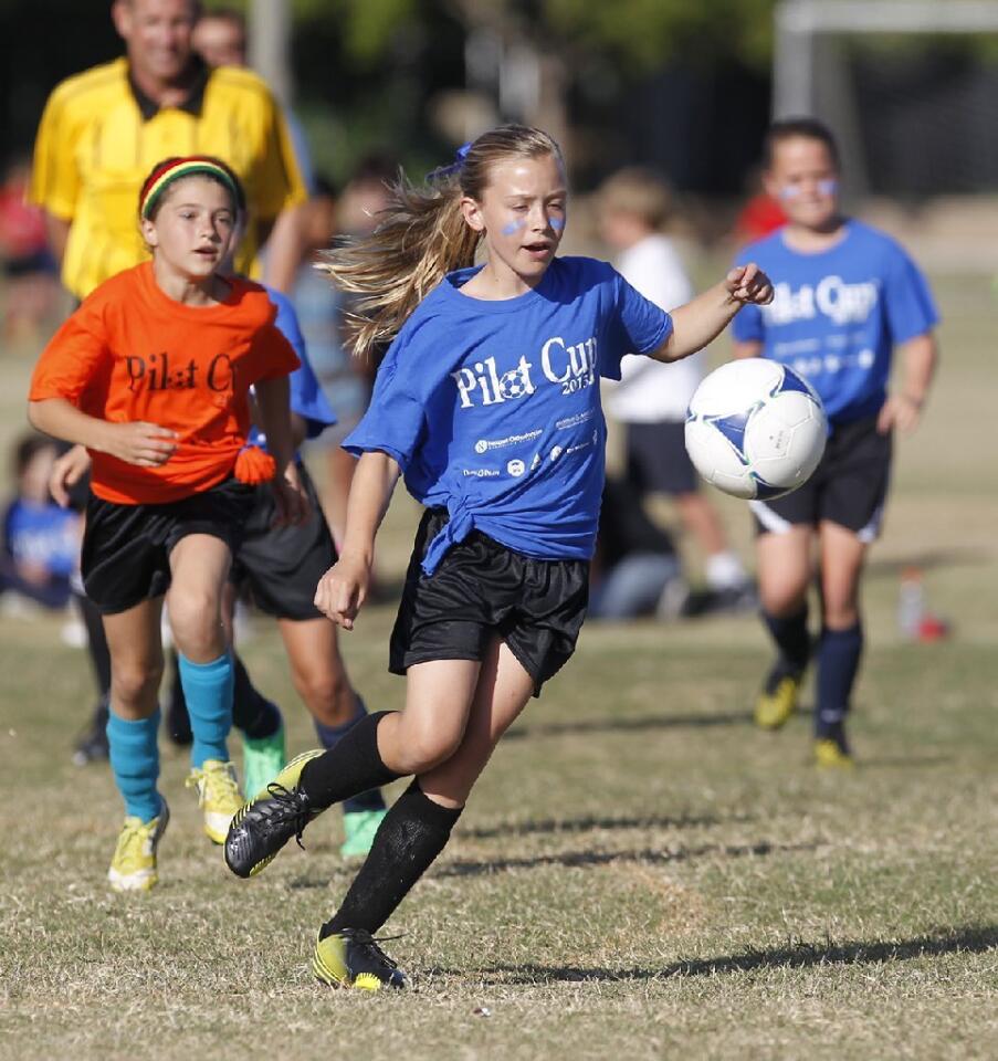 Our Lady Queen of Angels player Annie Gibson dribbles the ball up in a Daily Pilot Cup girls' 3-4 gold division game against Davis, Wednesday.