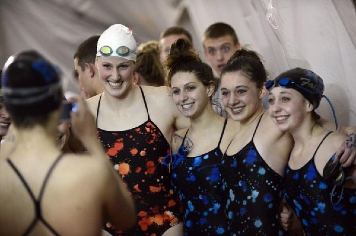 Olympic gold medalist and Regis Jesuit High School swimmer Missy Franklin, left, poses with Highlands Ranch High School swimmers after a meet.
