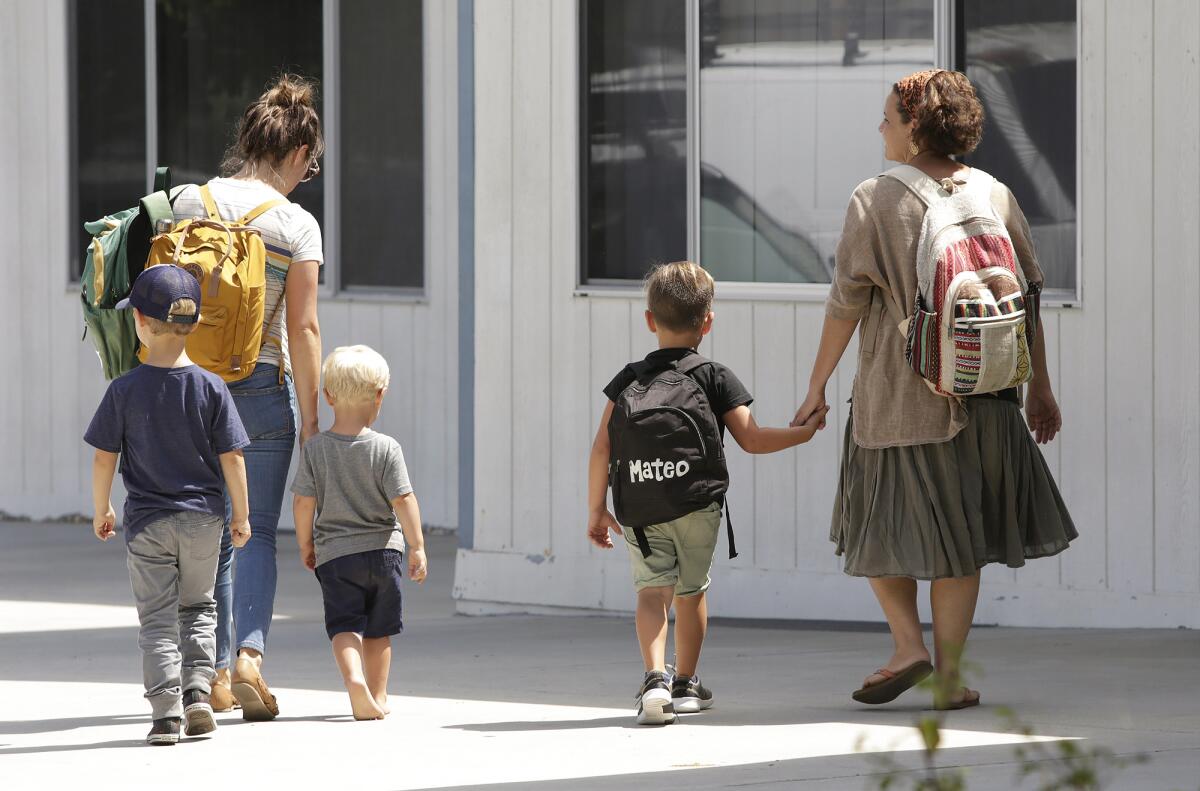 Parents pick up their children from the new Sycamore Creek Community Charter School in Huntington Beach on its second day of school Thursday.