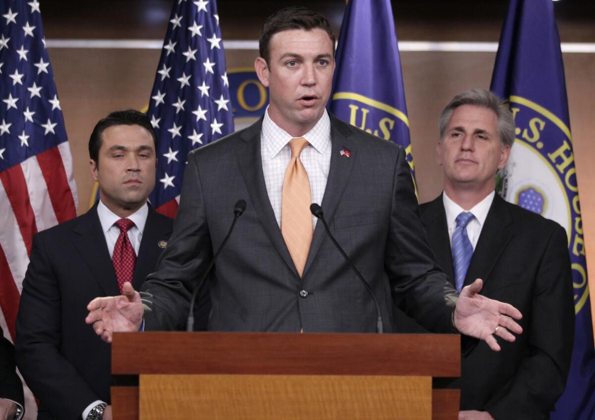 Rep. Duncan Hunter, R-Calif., center, speaks during a news conference on Capitol Hill on Thursday, April 7, 2011.