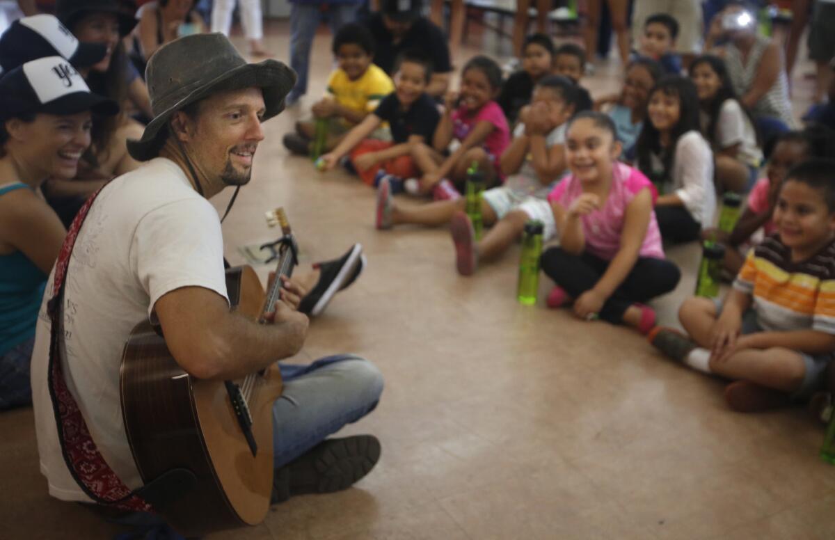 Jason Mraz is shown performing for children at Burbank Elementary School in San Diego.