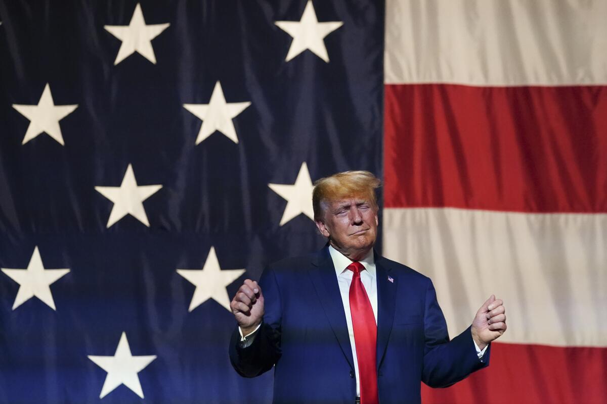 Former President Trump speaks at the Georgia Republican convention in front of a huge American flag.