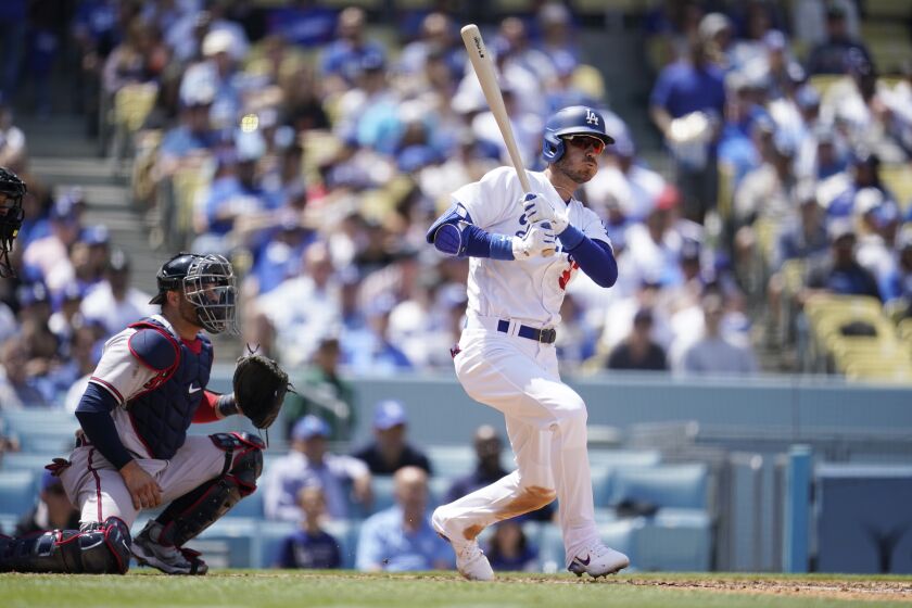 Los Angeles Dodgers' Cody Bellinger follows through on an RBI triple during the sixth inning of a baseball game against the Atlanta Braves Wednesday, April 20, 2022, in Los Angeles. (AP Photo/Marcio Jose Sanchez)