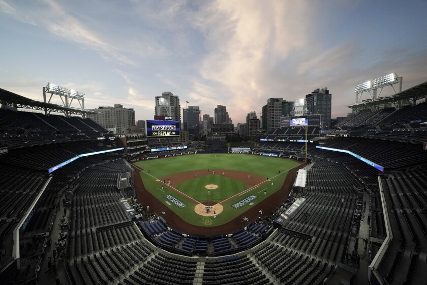 FILE - In this Oct. 6, 2020, file photo, the Tampa Bay Rays and the New York Yankees play in Game 2 of a baseball AL Division Series in an empty Petco Park in San Diego. Major League Baseball and all 30 of its teams are suing their insurance providers, citing billions of dollars in losses during the 2020 season played almost entirely without fans due to the coronavirus pandemic. The suit, filed in October in California Superior Court in Alameda County, was obtained Friday, Dec. 4, by The Associated Press. It says providers AIG, Factory Mutual and Interstate Fire and Casualty Company have refused to pay claims made by MLB despite the league's “all-risk” policy purchases. (AP Photo/Jae C. Hong, File)