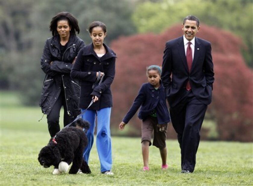 Malia Obama walks with new dog Bo, followed by President Barack Obama, Sasha Obama and first lady Michelle Obama on the South Lawn at the White House in Washington, Tuesday, April 14, 2009. (AP Photo/Charles Dharapak)