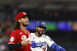LOS ANGELES, CALIFORNIA - JULY 28: Amed Rosario #31 of the Los Angeles Dodgers doubles against the Cincinnati Reds.