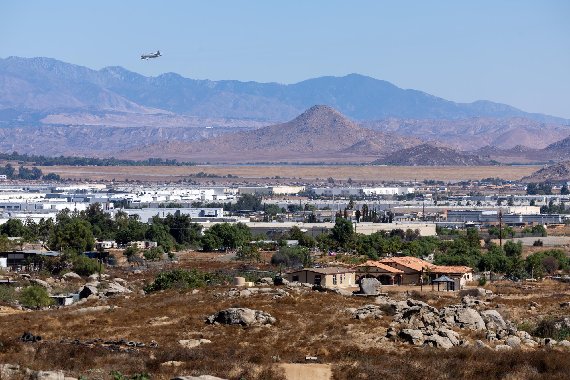 An aerial view shows the sharp delineation between the industrial corridor and rural residential land in Mead Valley.