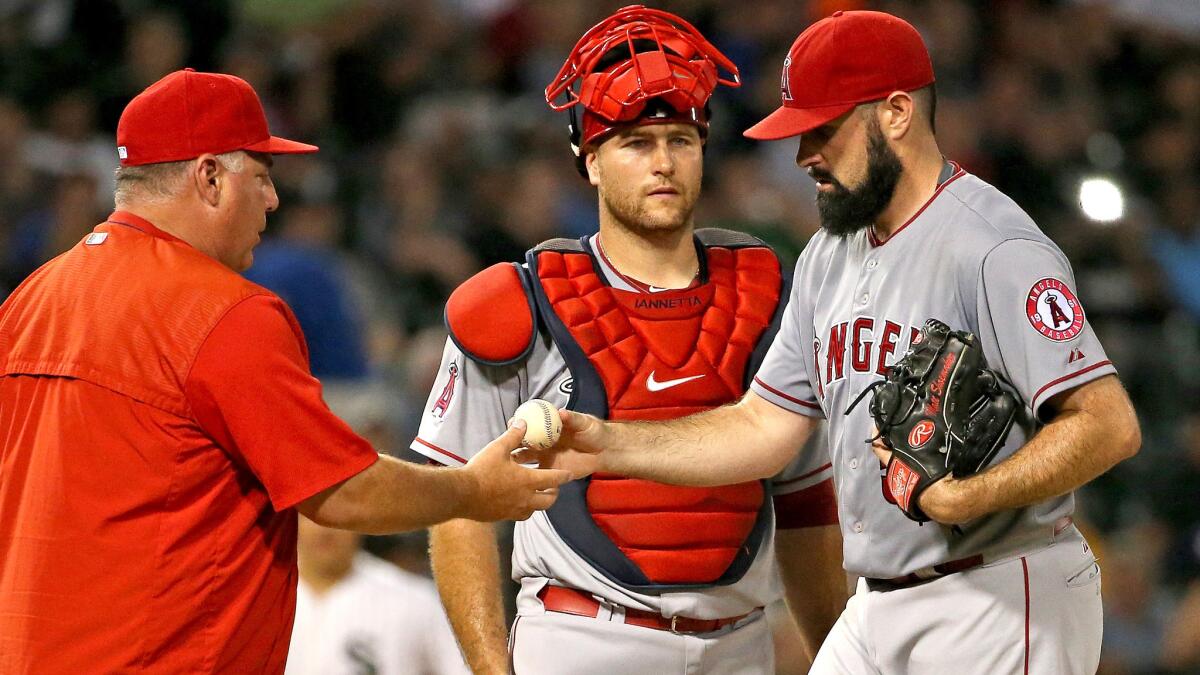 Angels starting pitcher Matt Shoemaker gives the ball to Manager Mike Scioscia after failing to record an out against six White Sox batters in the sixth inning Monday night in Anaheim.