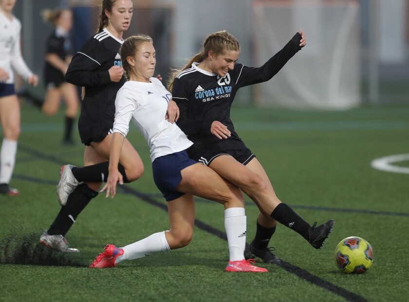 Newport Harbor's Anto Russo (10) battles Corona del Mar's Brea Sofferman during Battle of the Bay girls' soccer on Thursday.