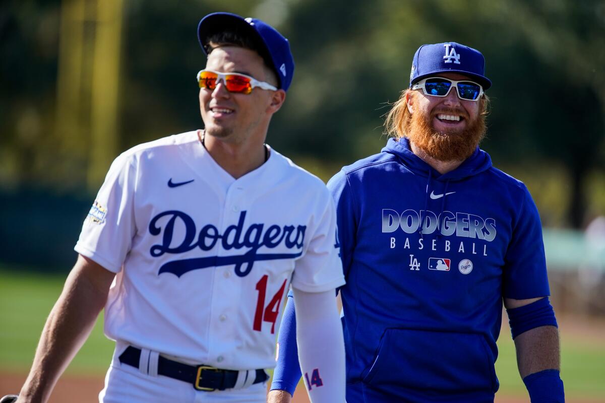 Dodgers teammates Kiké Hernández, left, and Justin Turner walk off the field after practice at Camelback Ranch on Feb. 20.