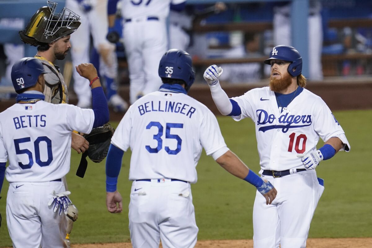 Dodgers' Justin Turner celebrates his three-run home run with Cody Bellinger and Mookie Betts.