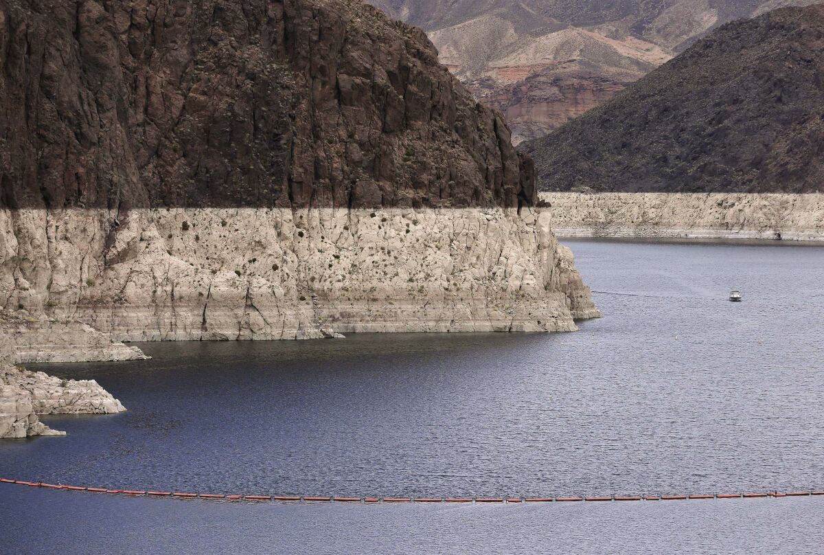 Lake Mead snakes through canyon walls marked by a water line.