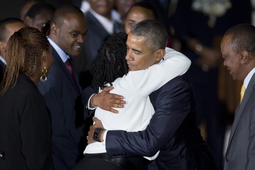 President Barack Obama hugs his half-sister, Auma Obama, accompanied by Kenya's President Uhuru Kenyatta, right, as he arrives in Nairobi.