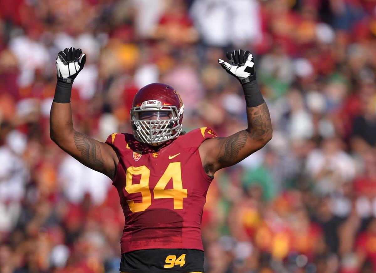 USC defensive end Leonard Williams gestures to fans during the Trojans' 49-14 victory over Notre Dame.