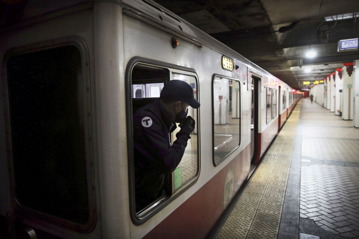 The operator of an inbound Red Line train, left, watches activity on the platform before departing the Broadway station, in Boston, April 12, 2022. A passenger door on a Boston subway car did not function properly when thirty-nine-year-old Robinson Lalin got his arm stuck in it and was dragged to his death last month, federal investigators said Monday, May 2, 2022. (Craig F. Walker/The Boston Globe via AP)