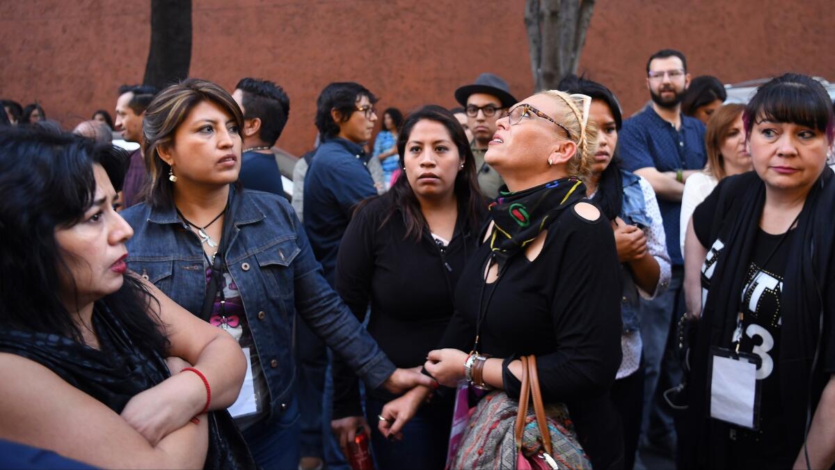 A crowd gathers outside the Holiday Inn on Insurgentes Avenue in Mexico City after the earthquake, centered 225 miles south.