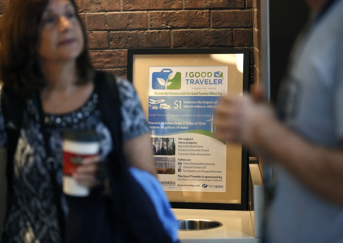 Carmine Ryan, right, of Ryan Bros. Coffee talks with customers about the Good Traveler program at the San Diego International Airport on August 27, 2019.