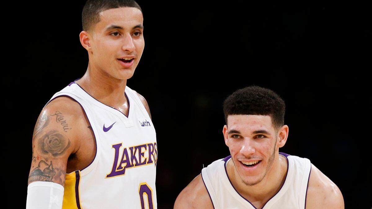 Lakers forward Kyle Kuzma, left, and guard Lonzo Ball in the first half of a game against the Denver Nuggets on Nov. 19, 2017.