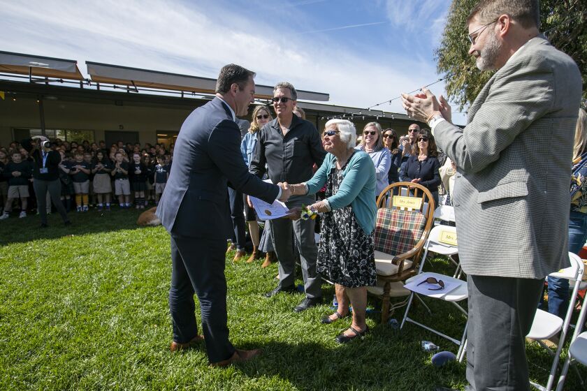 Newport Beach, CA - March 31: Mayor Pro Tem, Will O'Neill, left, shakes hands with Jane Jones, co-founder and current Director of Academics during Carden Hall's historic 60th Anniversary celebration on Friday, March 31, 2023 in Newport Beach, CA. (Scott Smeltzer / Daily Pilot)