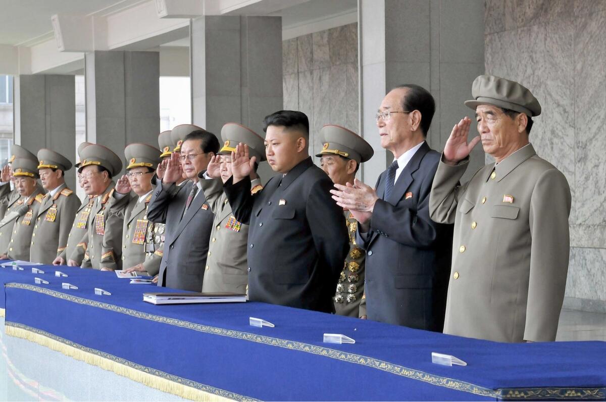 North Korean leader Kim Jong Un, fourth from right, accompanied by senior officials, inspects a parade of the Worker-Peasant Red Guards at Kim Il Sung Square in Pyongyang.