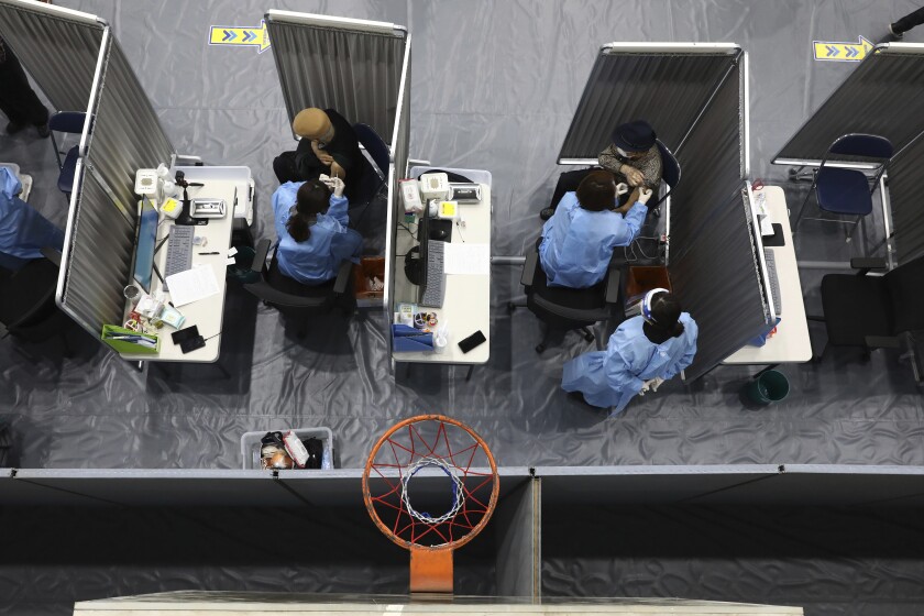 South Korean elderly people receive the first dose of the Pfizer-BioNTech COVID-19 vaccine at a vaccination center in Seoul, South Korea, Thursday, April 1, 2021. South Korea started its coronavirus vaccination for senior citizens over 75 years old. (Chung Sung-Jun/Pool Photo via AP)