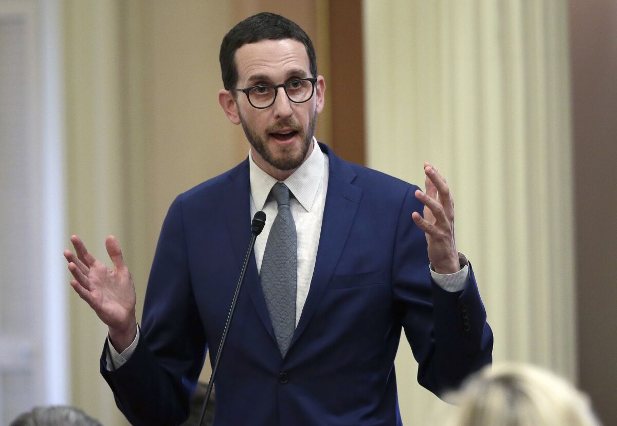 FILE - In this June 28, 2018, file photo, state Sen. Scott Wiener, D-San Francisco, talks during a Senate session in Sacramento, Calif. On Tuesday, Jan. 4, 2022, Wiener said he is withdrawing a bill that would have banned some medically unnecessary surgeries on intersex children until they are old enough to participate in the decision. Intersex refers to people with genitalia, chromosomes or reproductive organs that don’t fit typical definitions for male or female bodies. The California Medical Association has opposed similar proposals. Wiener said he is not giving up and will continue to fight for the intersex community. (AP Photo/Rich Pedroncelli, File)